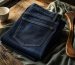 Flat-lay of neatly folded indigo jeans with tailor's measuring tape, soft natural light, minimalist muted palette